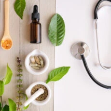 functional medicine depicted by a stethoscope and herbal remedies